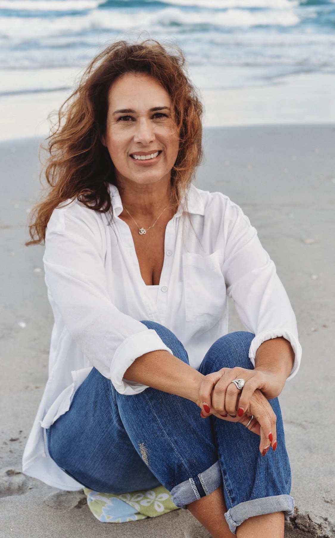 Claudia Rotman seated by the ocean